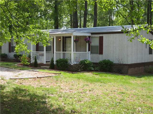 7500 Rock Service Station Road Raleigh, NC 27603 - Photo 1 of 21 a view of a house with backyard and garden