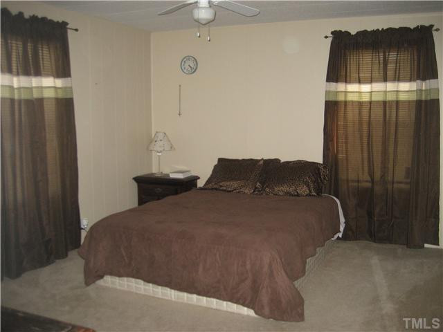 7500 Rock Service Station Road Raleigh, NC 27603 - Photo 12 of 21 a bedroom with a bed and a cabinets