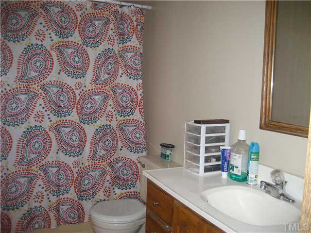 7500 Rock Service Station Road Raleigh, NC 27603 - Photo 13 of 21 a bathroom with a sink and mirror with toilet