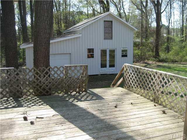 7500 Rock Service Station Road Raleigh, NC 27603 - Photo 16 of 21 a view of a wooden deck front of house