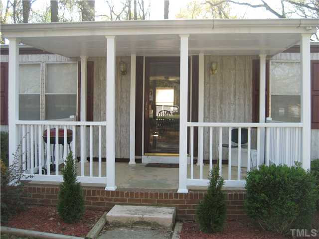 7500 Rock Service Station Road Raleigh, NC 27603 - Photo 2 of 21 front view of a house with a porch