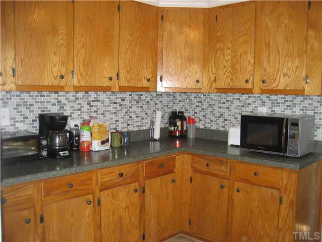 7500 Rock Service Station Road Raleigh, NC 27603 - Photo 7 of 21 a kitchen with sink cabinets and appliances