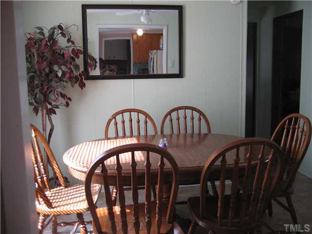 7500 Rock Service Station Road Raleigh, NC 27603 - Photo 9 of 21 a view of a balcony dining table and chairs