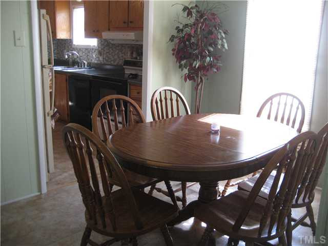 7500 Rock Service Station Road Raleigh, NC 27603 - Photo 10 of 21 a view of a dining room with furniture and window