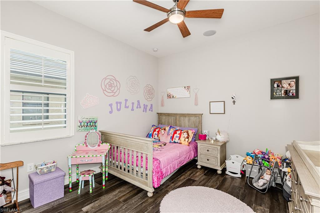 7307 Acorn Way Naples, FL 34119 - Photo 14 of 22 Bedroom with dark wood-type flooring and ceiling fan