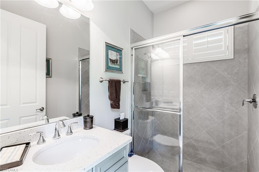 7307 Acorn Way Naples, FL 34119 - Photo 16 of 22 Bathroom with vanity and a shower stall