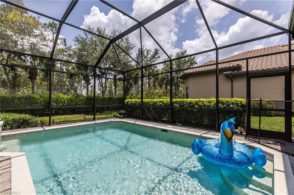 7307 Acorn Way Naples, FL 34119 - Photo 19 of 22 View of pool featuring a lanai and a sunroom