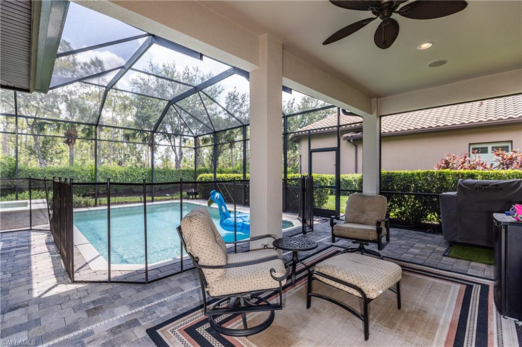 7307 Acorn Way Naples, FL 34119 - Photo 22 of 22 View of pool featuring a patio area, a lanai, and a sunroom