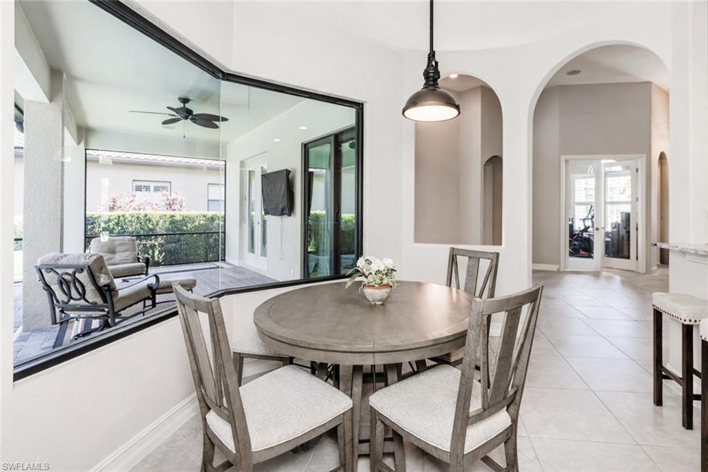 7307 Acorn Way Naples, FL 34119 - Photo 6 of 22 Dining room with light tile patterned flooring, a ceiling fan, and french doors