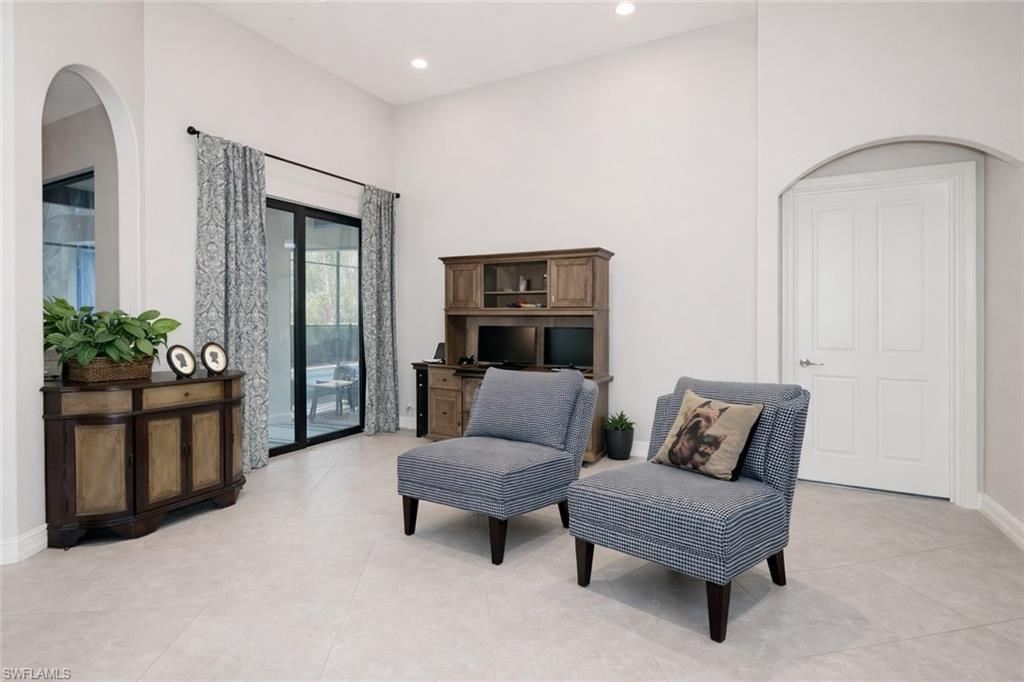 7307 Acorn Way Naples, FL 34119 - Photo 8 of 22 Living area featuring recessed lighting, a high ceiling, arched walkways, and light tile patterned floors
