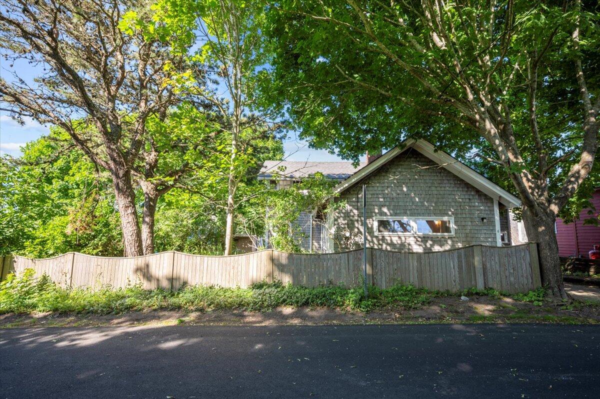 6 Priscilla Alden Road Provincetown, MA 02657 - Photo 12 of 58 a front view of a house with a yard and a trees