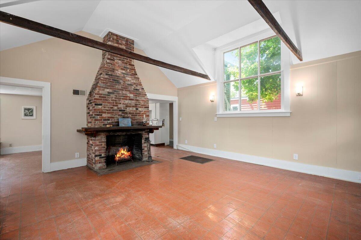 6 Priscilla Alden Road Provincetown, MA 02657 - Photo 14 of 58 an empty room with a fireplace and a window