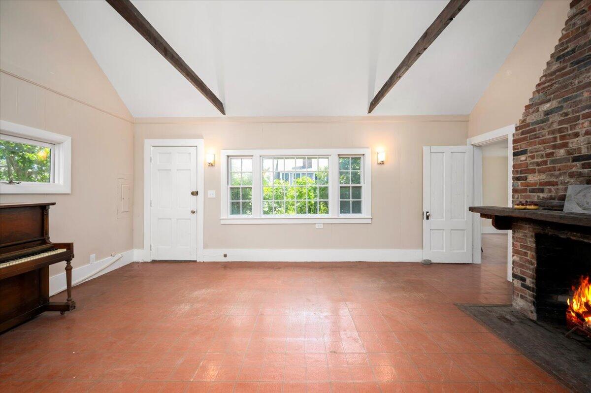 6 Priscilla Alden Road Provincetown, MA 02657 - Photo 20 of 58 a view of empty room with a fireplace and windows