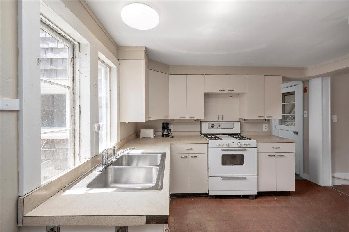 6 Priscilla Alden Road Provincetown, MA 02657 - Photo 27 of 58 a kitchen with a stove sink and white cabinets