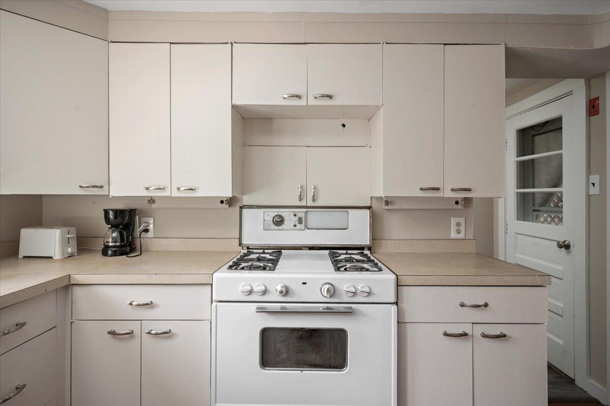 6 Priscilla Alden Road Provincetown, MA 02657 - Photo 28 of 58 a kitchen with kitchen island a stove a sink and a refrigerator