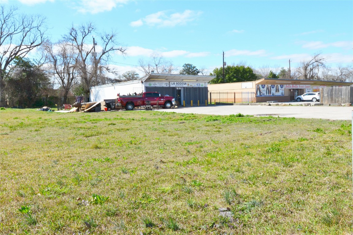 a front view of a house with a yard and lake view