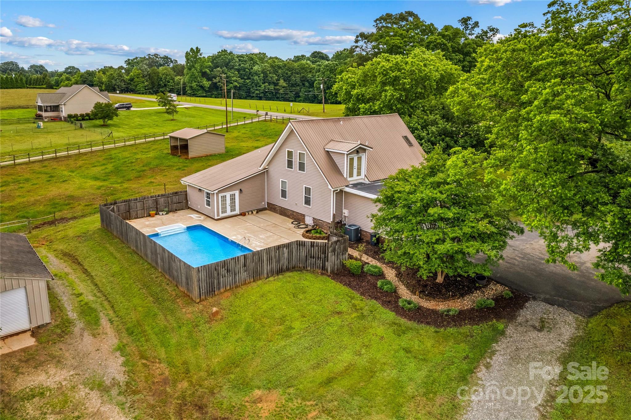 296 Hicks Creek Road Troutman, NC 28166 - Photo 3 of 48 an aerial view of a house with a garden and swimming pool