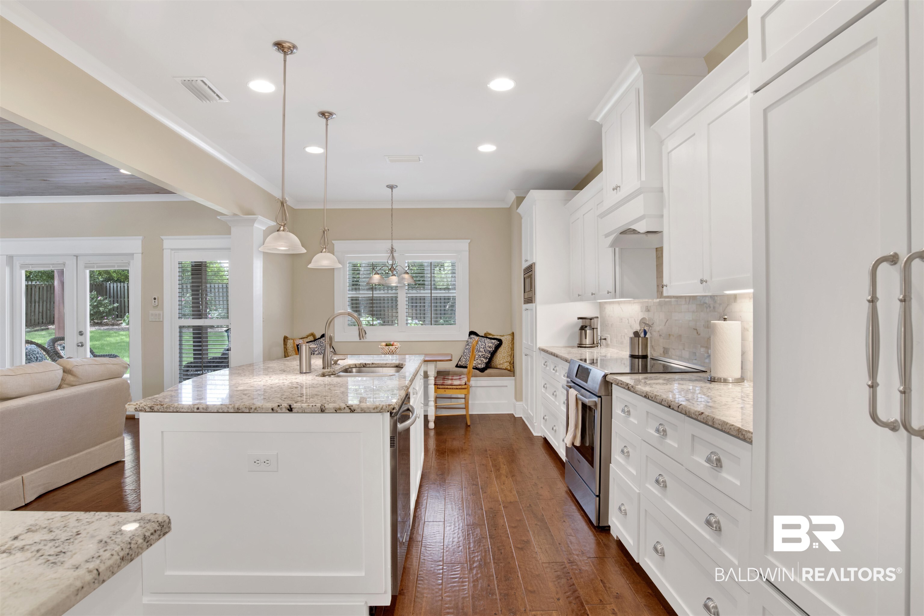 131 Sedgefield Avenue Fairhope, AL 36532 - Photo 18 of 50 Kitchen with appliances with stainless steel finishes, crown molding, sink, and dark hardwood / wood-style flooring