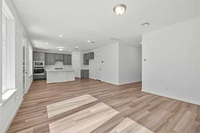 a view of kitchen and empty room