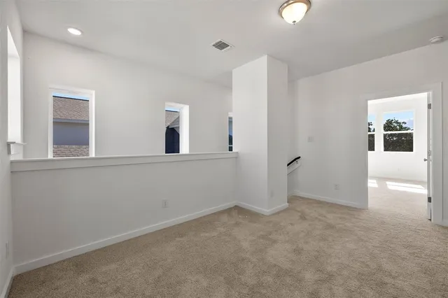 an empty room with windows and entrance