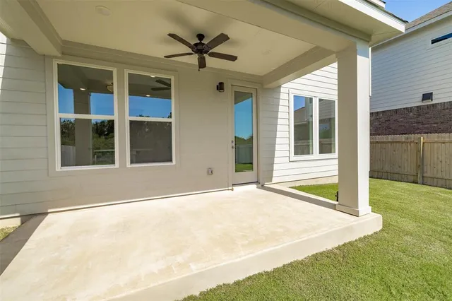 a view of an house with backyard and porch