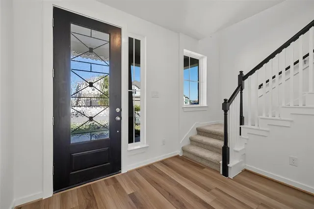 a view of entryway and hall with wooden floor