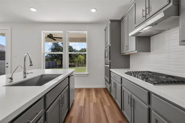 a kitchen that has a sink and a stove