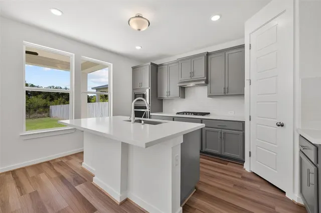 a kitchen with stainless steel appliances granite countertop a sink and cabinets