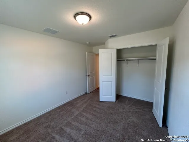 an empty room with closet area