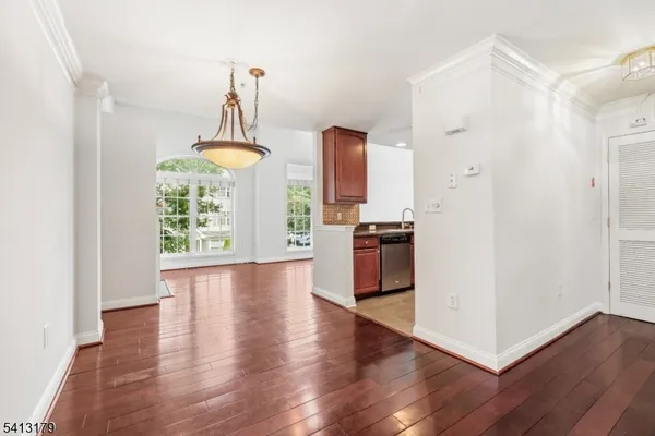 a view of a kitchen with wooden floor and electronic appliances