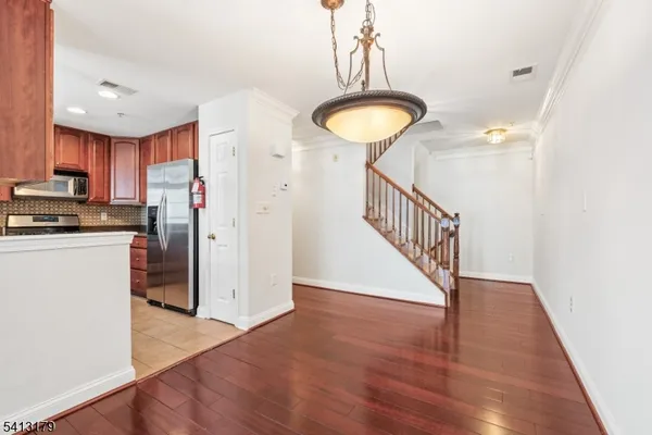 a view of a kitchen with a sink and a refrigerator