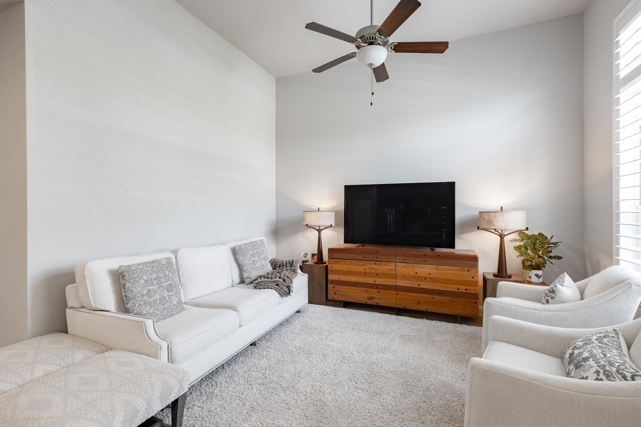 7801 Frida Bend Austin, TX 78744 - Photo 11 of 26 A living room showcasing high ceilings and a ceiling fan for optimal comfort.