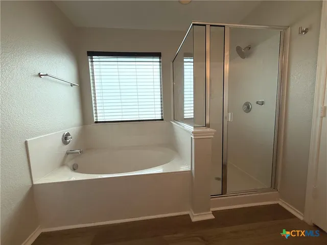 a bathroom with a bathtub and a shower