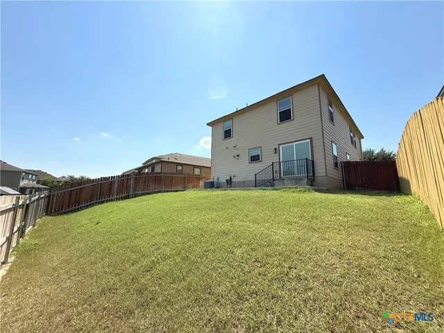 a backyard of a house with lots of green space and mountain view