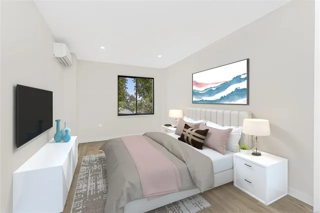 a bedroom with double bed and a flat screen tv