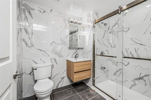 a bathroom with a toilet sink and shower
