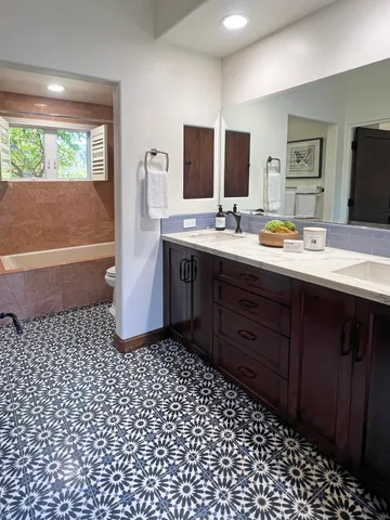 a bathroom with a sink a toilet and mirror