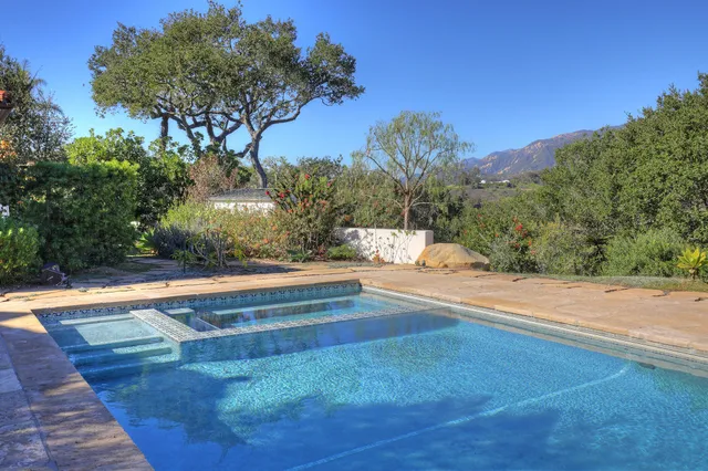 a view of a backyard with a table and chairs
