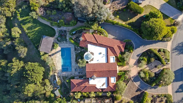 an aerial view of residential house and car parked