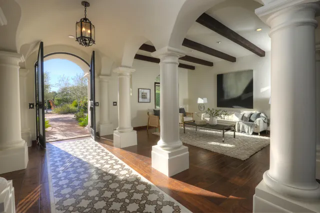 a view of living room with granite countertop couches with wooden floor