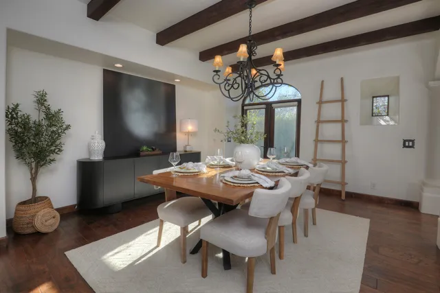a view of a dining room with furniture wooden floor and chandelier