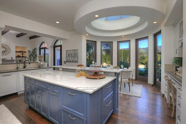 a kitchen with granite countertop a sink and a stove
