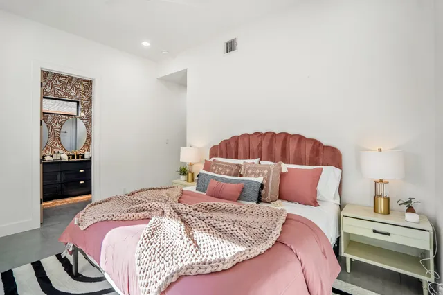 a bedroom with a bed and dresser