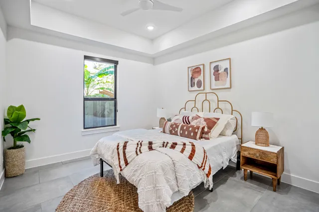 a bedroom with a bed and a window