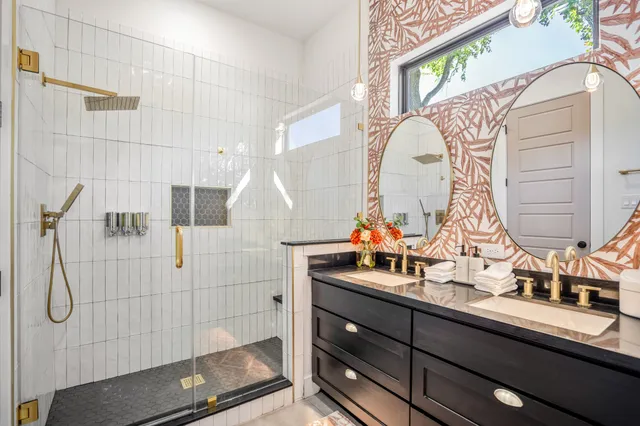 a bathroom with a double vanity sink and a mirror