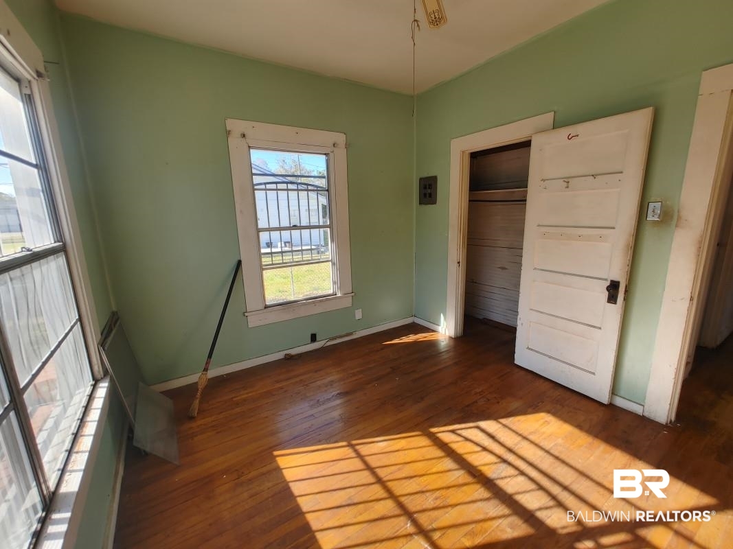 1706 Lomeroy Street Mobile, AL 36604 - Photo 13 of 24 Unfurnished bedroom with baseboards and dark wood-style flooring