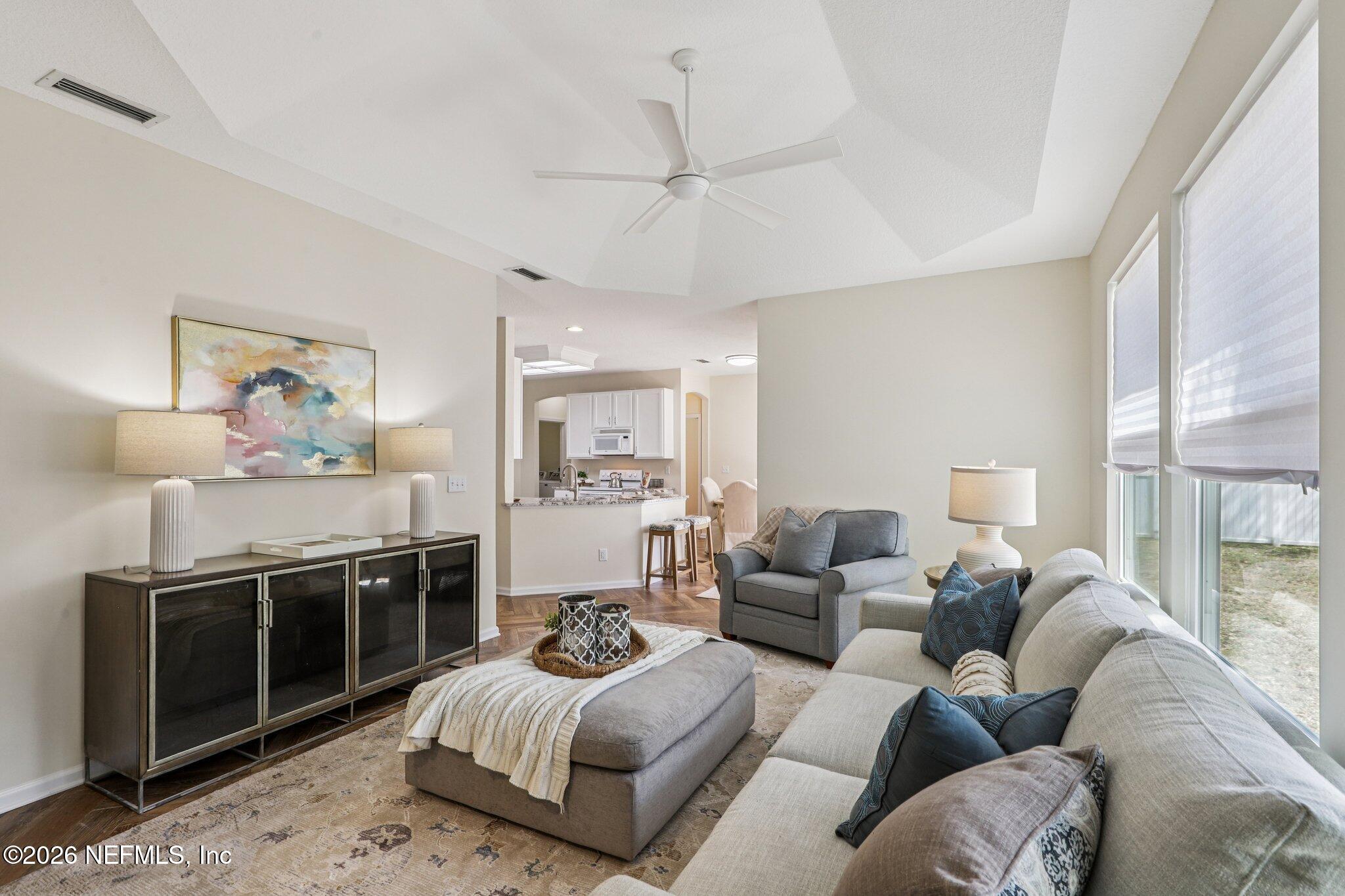 1001 Andrea Way St. Johns, FL 32259 - Photo 11 of 61 a living room with furniture a rug and a chandelier