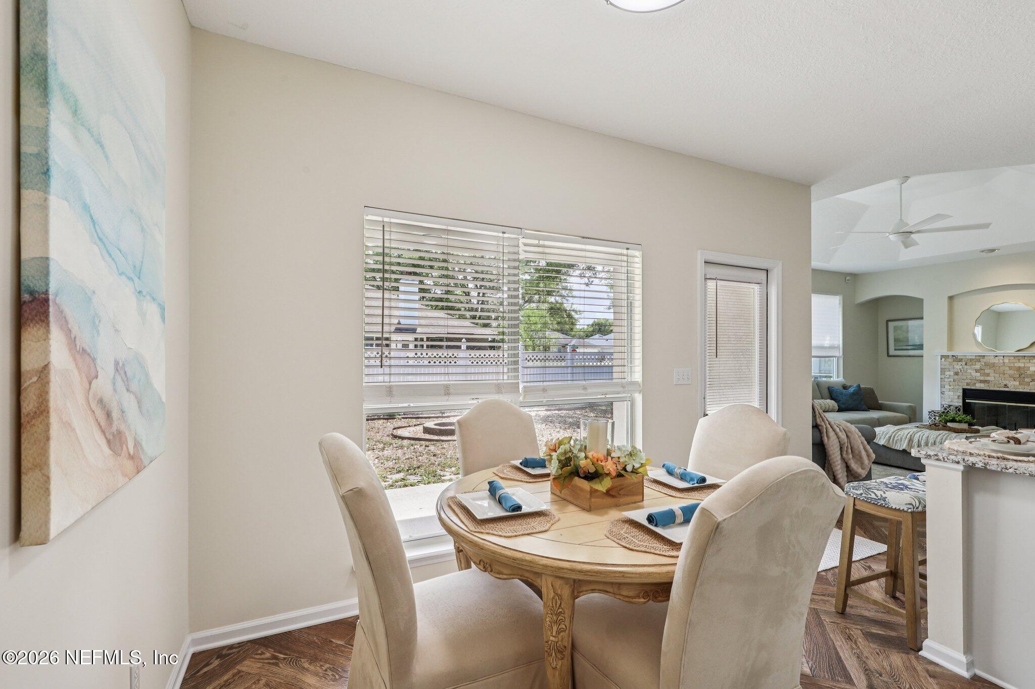 1001 Andrea Way St. Johns, FL 32259 - Photo 14 of 61 a dining room with furniture a large window and a fireplace