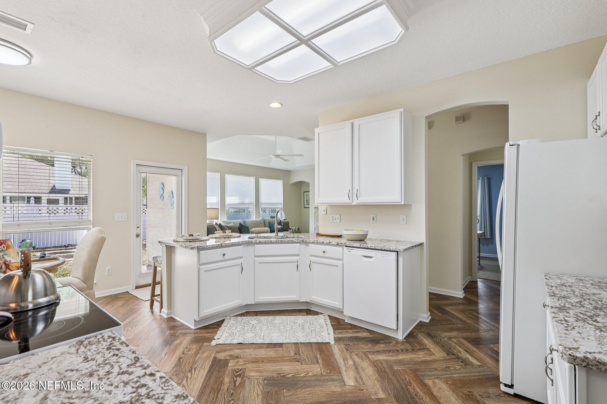 1001 Andrea Way St. Johns, FL 32259 - Photo 15 of 61 a kitchen with stainless steel appliances granite countertop a refrigerator a stove and white cabinets with wooden floor