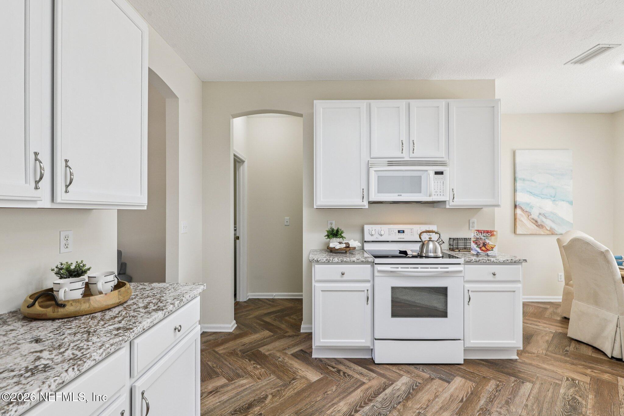 1001 Andrea Way St. Johns, FL 32259 - Photo 16 of 61 a kitchen with stainless steel appliances granite countertop a sink stove and refrigerator